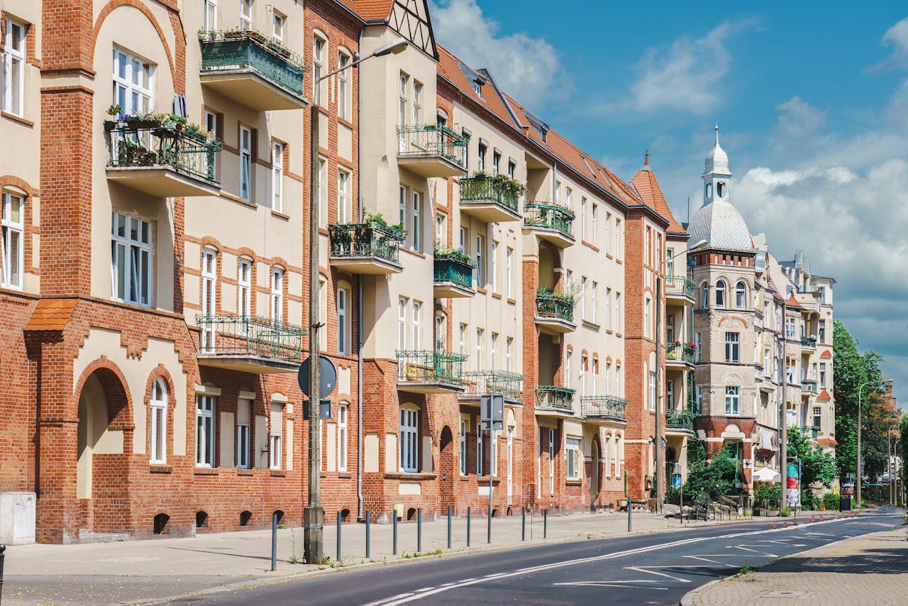 Explore the classic architecture on a sunny street in Poznań, Poland, showcasing rich history.